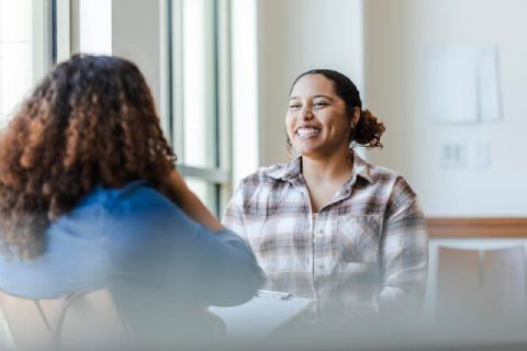 An image of two female students chatting