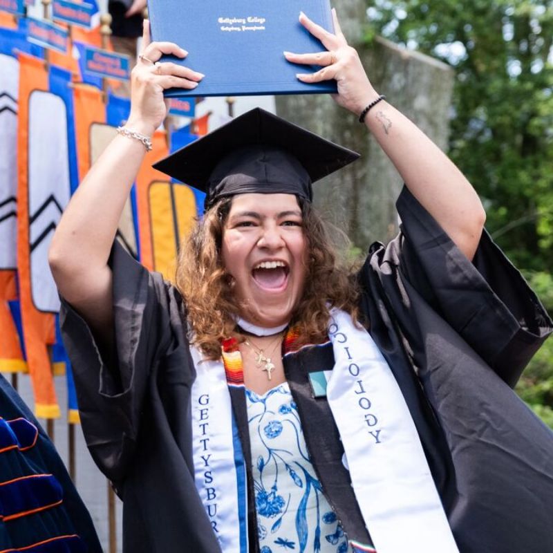 Student holding up her degree
