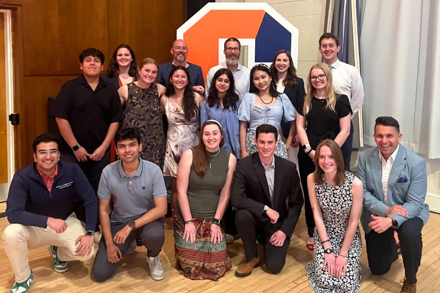 A group of students and professors posing together for a photo.