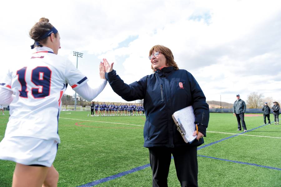 An image of Carol Daly Cantele ’83, P’15 with an athlete 
